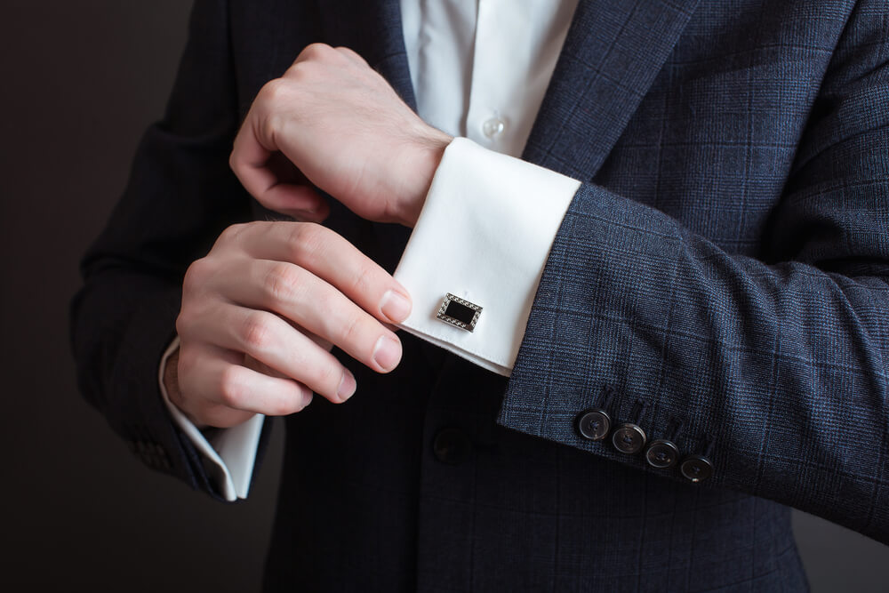 man wearing cufflinks with a suit