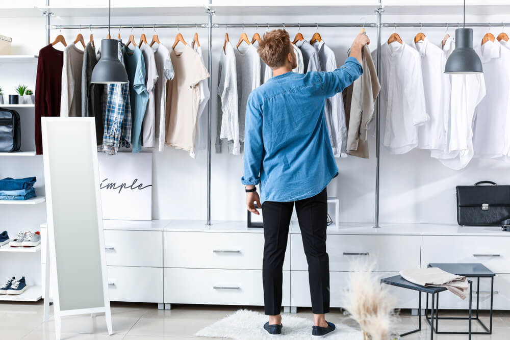 man adding shirt to his wardrobe