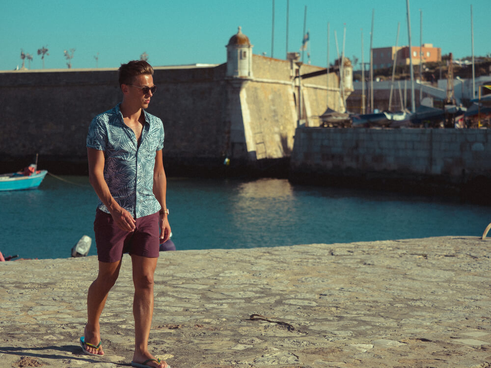 man wearing floral shirt on the beach