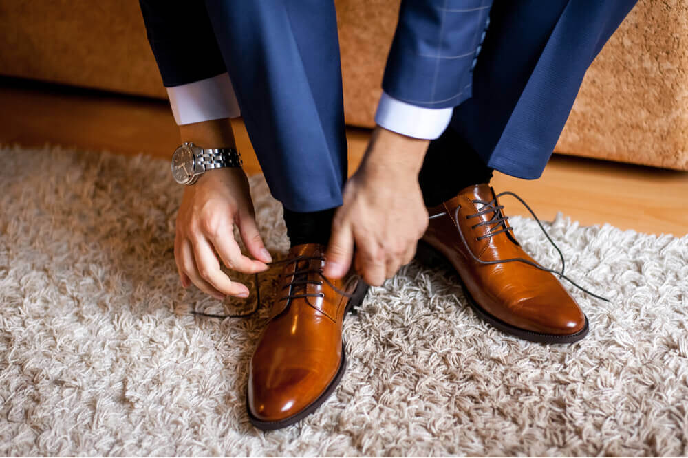 navy suit tan shoes