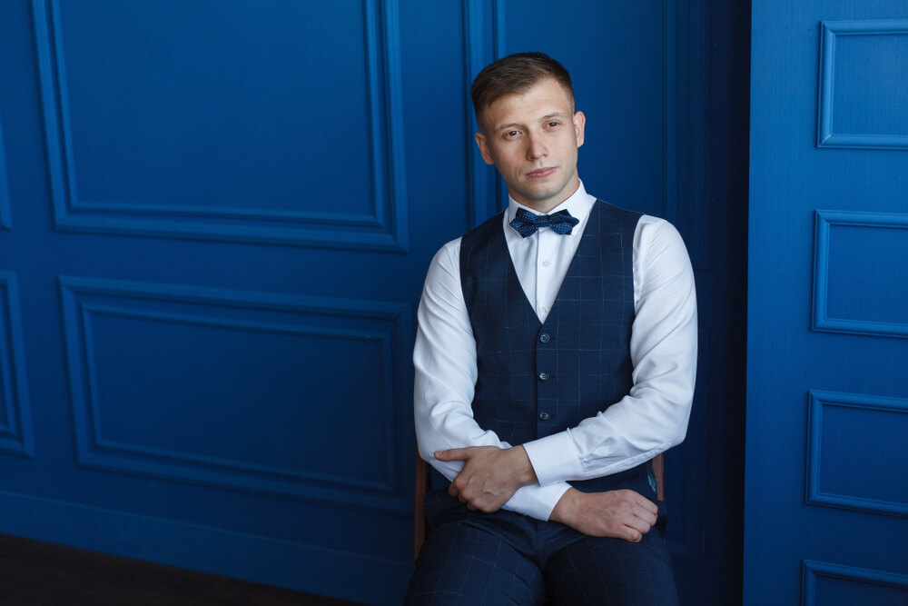 man wearing a blue waistcoat