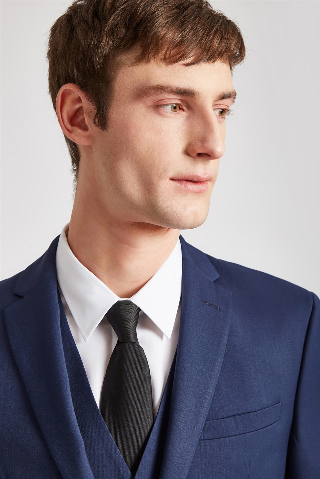 A head shot of a man wearing a Ted Baker blue twill slim fit suit jacket.