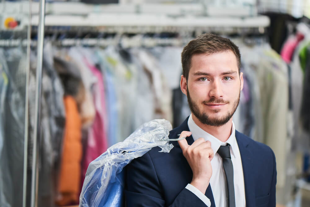 man in suit at dry cleaners